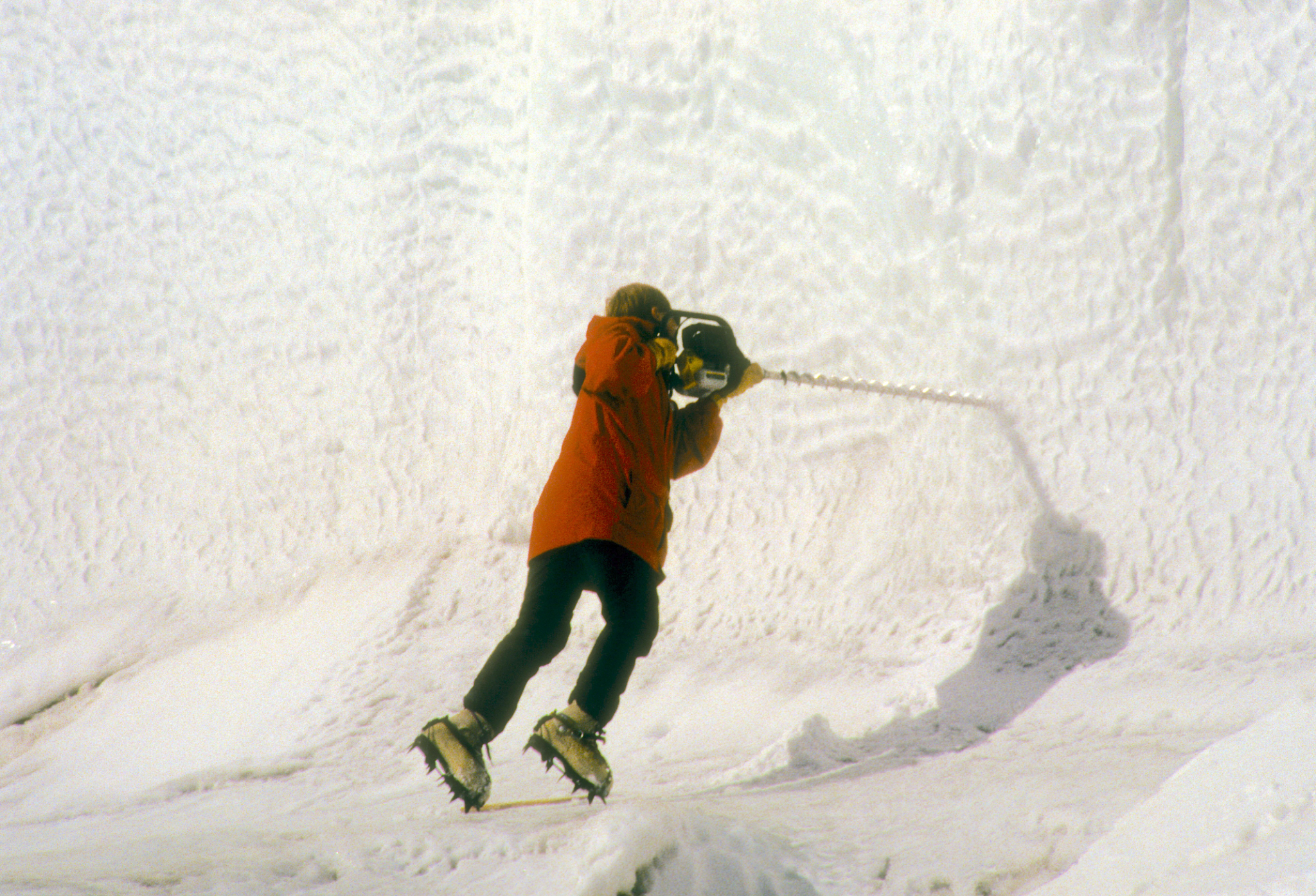 Drilling into glacier wall to set ablation stakes
